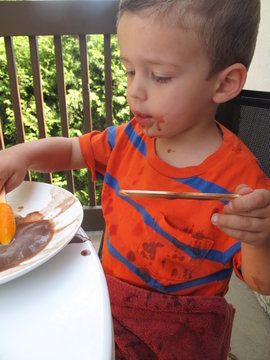 Young Child Eating Popsicles Outdoors