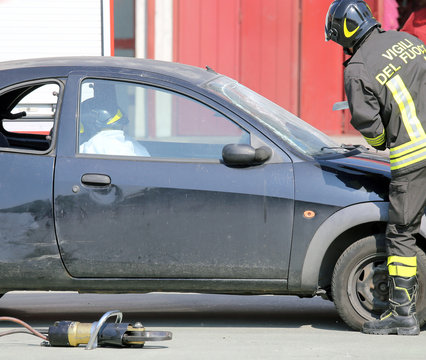 firefighter during training exercise cuts the windscreen of the