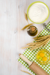 Baking ingredients and utensils background with side copyspace