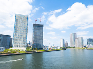 Obraz premium building and cranes under construction against blue sky