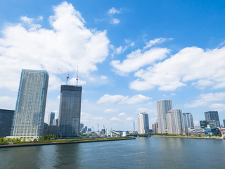 Obraz premium building and cranes under construction against blue sky