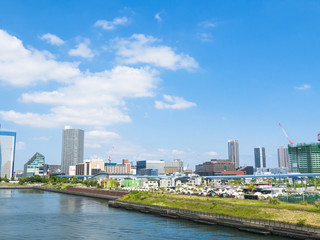 Fototapeta premium building and cranes under construction against blue sky