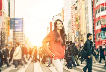 Fotobehang young girl walking on the streets of tokyo © oneinchpunch