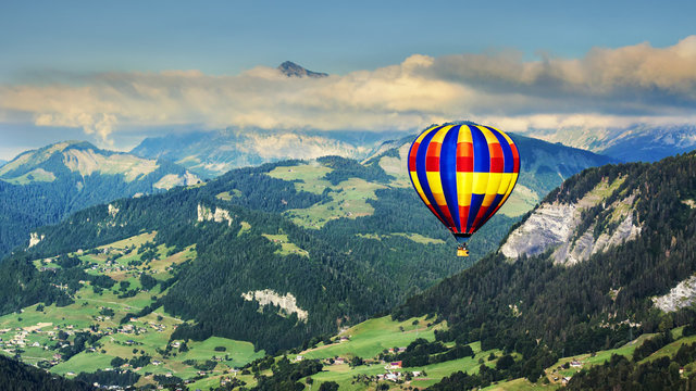Panoramic view of mountains with a hot air balloon