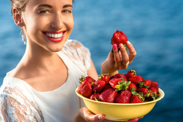 Woman eating strawberry