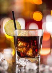 Glass of cola drink on bar counter