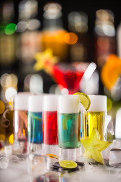 Variation of hard alcoholic shots on bar counter