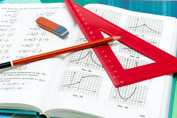 school supplies and textbooks on mathematics close up - obrazy, fototapety, plakaty