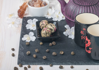 Asian tea set with dried green tea and sugar