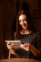 Beautiful girl working on a tablet and smiling