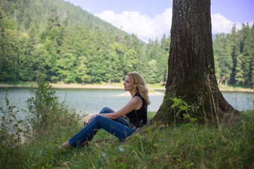 Woman sitting near the lake