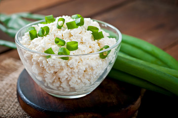 Useful cottage cheese with chives in a glass bowl