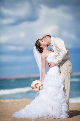 Fototapeta na wymiar Kissing bride groom wedding day outdoors