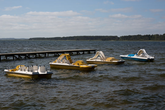 Image of blue and yellow Pedalos on a lake