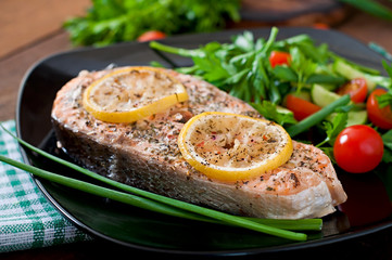 Baked salmon steak with lemon and herbs