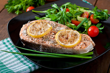 Baked salmon steak with lemon and herbs