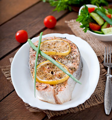 Baked salmon steak with lemon and herbs