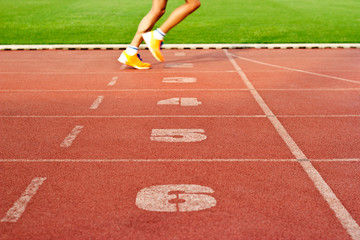  Number lanes track and athlete running on number lanes