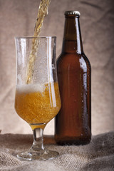 pouring beer from bottle into glass
