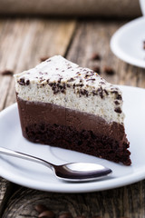 Chocolate dessert with coffee cup and coffee beans on wooden bac