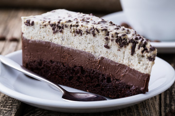 Chocolate dessert with coffee cup and coffee beans on wooden bac