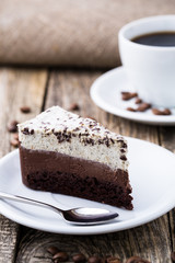 Chocolate dessert with coffee cup and coffee beans on wooden bac