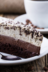 Chocolate dessert with coffee cup and coffee beans on wooden bac