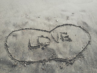 Love word engraved on the sand