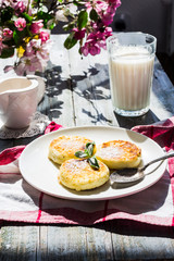 cottage cheese pancakes with mint and powdered sugar, flowers, b