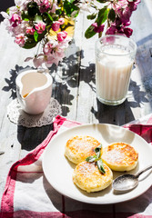 cottage cheese pancakes with mint and powdered sugar, flowers, b