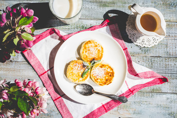 cottage cheese pancakes with mint and powdered sugar, flowers, b