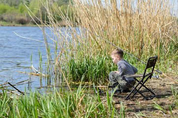 Fototapeta na wymiar Young boy fishing with a rod and reel