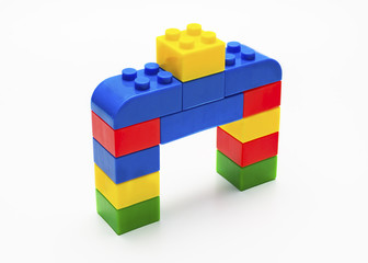 Colorful stacked toy building blocks with shape of house.