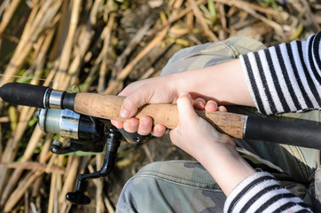 Young boy fishing with a spinning reel