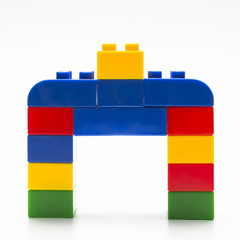 Colorful stacked toy building blocks with shape of house. - 83664687