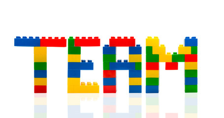 Team word build from toy building blocks