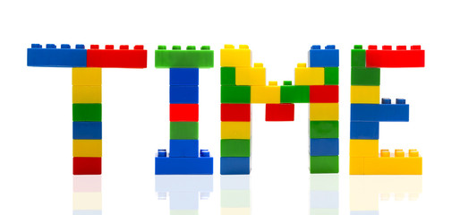 Time word build from toy building blocks.