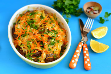 liver pancakes with onions and carrots in the baking dish 