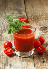Fresh tomato juice with herbs and tomatoes, selective focus