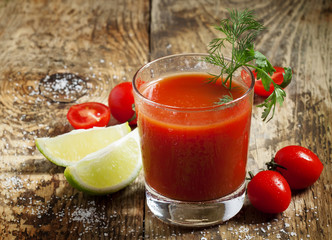 Red cocktail with tomato juice, lime and salt, selective focus