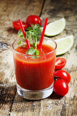 Red cocktail with tomato juice, lime and salt, selective focus