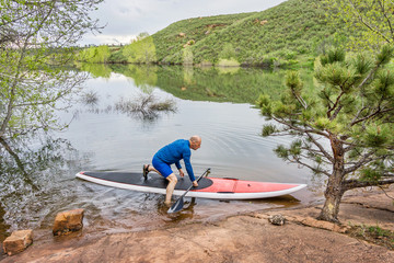 senior paddler launching paddleboard