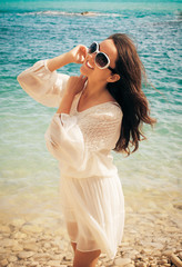 Fototapeta na wymiar Happy woman in summer white dress on beach.