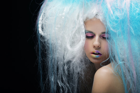 young woman with bright make up and creative hair