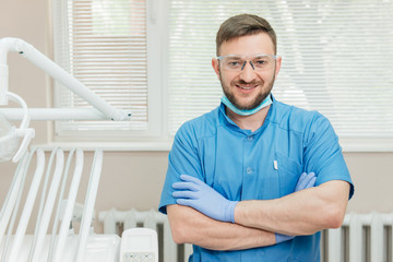 Portrait of smiling dentist in the dental office