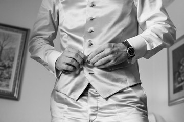 man buttons white shirt