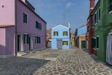 Fototapeta na wymiar Colorful narrow street in Burano island, near Venice, Italy