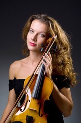 Female musical player against dark background