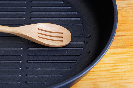 Empty frying pan and wooden utensils