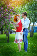 Obraz premium young couple in love walking at the blossoming spring